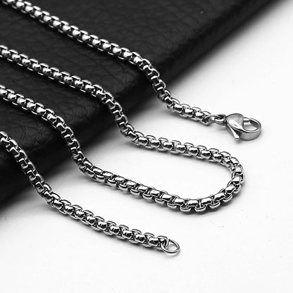 Stainless steel rolo chain necklace on a dark background