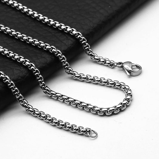 Stainless steel rolo chain necklace on a dark background