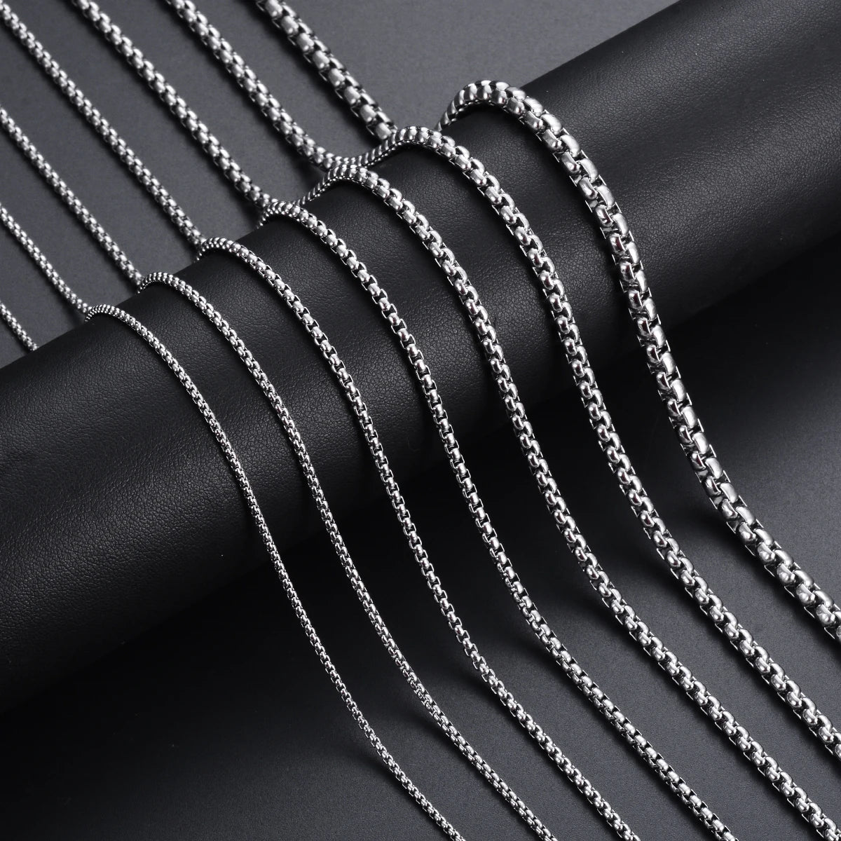 Stainless steel chain necklace shown in multiple widths